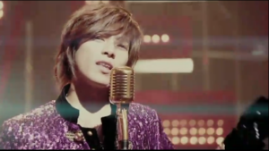 Singer in purple sequined jacket at microphone