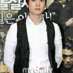 Man in white shirt and black vest