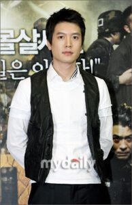 Man in white shirt and black vest