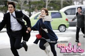 Couple running hand-in-hand on snowy street