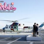 Helicopter on rooftop helipad with three people