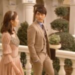 Man and woman in formal attire on balcony