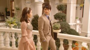 Man and woman in formal attire on balcony