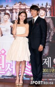 Smiling couple posing at movie premiere