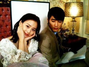 Smiling woman beside man reading papers