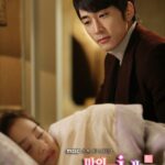 Man watching woman sleep in bedroom