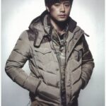 Man in tan puffer jacket with satchel