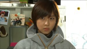 Portrait of young woman in gray coat