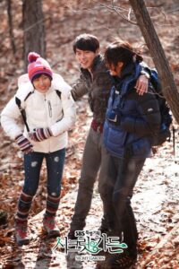 Three friends hiking in autumn forest