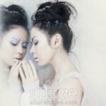 Woman with snowflake makeup touching frosted mirror