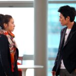 Two people facing each other in office