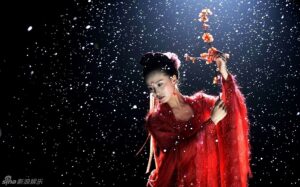 Red-robed dancer with blossom branch, snow