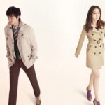 Man and woman wearing beige trench coats