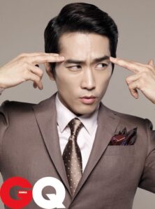 Man in suit pressing temples, concentrated expression
