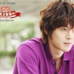 Young man in purple shirt looking contemplative