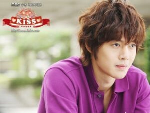 Young man in purple shirt looking contemplative