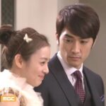 Young man in suit gazing at smiling woman