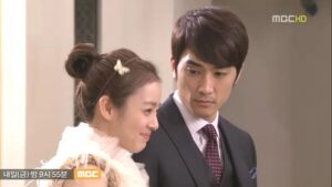 Young man in suit gazing at smiling woman