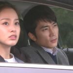 Two passengers in car looking forward