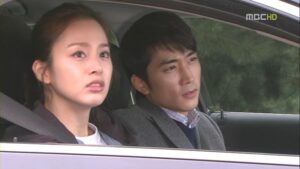 Two passengers in car looking forward