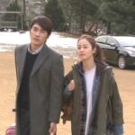 Man and woman walking near parked car