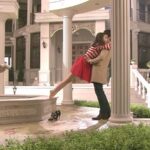 Man lifting woman in ornate courtyard