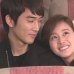 Young couple smiling while seated together