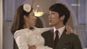 Well-dressed couple in romantic indoor embrace