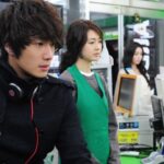 Young man with headphones in convenience store
