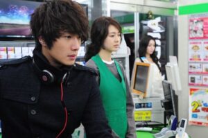 Young man with headphones in convenience store