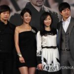 Four people posing at promotional event