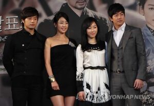 Four people posing at promotional event