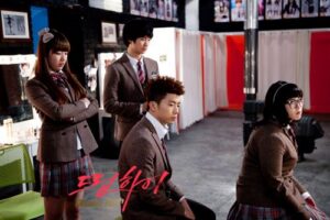 Four students in school uniforms in dressing room