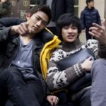 Two friends posing and gesturing on couch