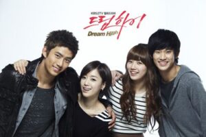 Four smiling young adults posing together