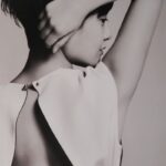 Black-and-white profile of person with raised arm