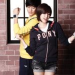 Two young people posing in sporty casual clothes
