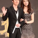 Man and woman posing at awards event