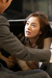Woman looking up inside car at man