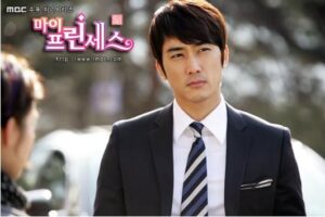 Man in suit and striped tie outdoors