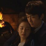 Couple embracing by cozy fireplace