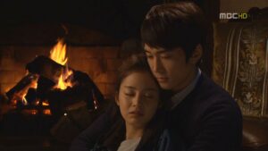 Couple embracing by cozy fireplace
