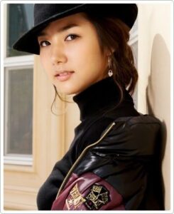 Young woman in black hat and leather jacket
