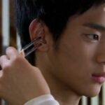 Person having ear cleaned with metal tool
