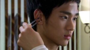 Person having ear cleaned with metal tool