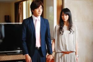 Young couple holding hands in living room