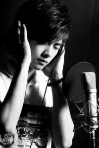 Singer recording vocals in studio with microphone