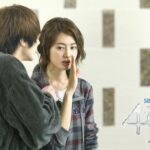 Young man whispering to young woman indoors