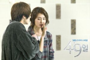 Young man whispering to young woman indoors