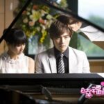 Young man and woman at grand piano